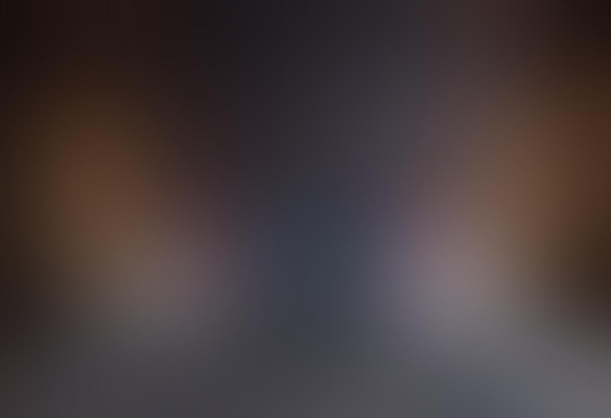 A sleek smartphone on a stylish bed surrounded by soft pillows and dim, romantic lighting, displaying a captivating scene from an erotic film. Include subtle hints of passionate imagery, shadow play, and suggestive elements but maintain a classy aesthetic. The background features a luxurious interior, with elegant decor that conveys intimacy. Create a sense of allure and curiosity, leading the viewer to explore further. super-realistic. vibrant colors. soft focus.